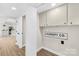 Functional laundry room with cabinets and a 'Laundry Co.' sign at 1133 Bloom Wood Ln, Matthews, NC 28105