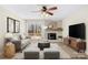 Comfortable living room with sofa, fireplace, hardwood floors, ceiling fan, and sliding glass doors to the deck at 1133 Bloom Wood Ln, Matthews, NC 28105