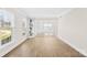 Bright and airy living room featuring neutral walls, hardwood floors, and a built-in shelving unit at 1133 Bloom Wood Ln, Matthews, NC 28105