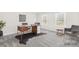 Home office featuring a modern desk, neutral walls, and two windows at 1133 Bloom Wood Ln, Matthews, NC 28105