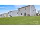 A spacious backyard with a manicured lawn and rear view of the home's siding at 115 Dorian Pl, Troutman, NC 28166