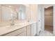 Well-lit bathroom with double vanity, white cabinets, and a large mirror, offering ample space at 115 Dorian Pl, Troutman, NC 28166