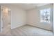 Comfortable bedroom featuring soft carpeting, a bright window, and a convenient walk-in closet at 115 Dorian Pl, Troutman, NC 28166
