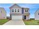 Charming two-story home featuring gray siding, a two-car garage, and a welcoming front entrance at 115 Dorian Pl, Troutman, NC 28166