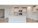 Modern kitchen with white cabinetry, stainless steel appliances, and a center island with a sink at 115 Dorian Pl, Troutman, NC 28166