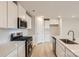 Stylish kitchen featuring white cabinets, subway tile backsplash, and stainless steel appliances at 115 Dorian Pl, Troutman, NC 28166