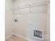Bright laundry room with sleek overhead storage and modern hookups for a washer and dryer at 115 Dorian Pl, Troutman, NC 28166