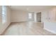 Bright and spacious living room with light wood floors and ample natural light from large windows at 115 Dorian Pl, Troutman, NC 28166