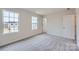 Spacious bedroom with gray carpet, two large windows, and neutral walls at 116 Dorian Pl, Troutman, NC 28166