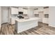 Modern kitchen featuring white cabinets, stainless steel appliances, and a center island with bar seating at 116 Dorian Pl, Troutman, NC 28166