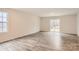 Bright living room boasts wood-look flooring and sliding glass doors to the outside at 116 Dorian Pl, Troutman, NC 28166