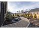 Landscaped backyard with a charming pebble path and water fountain at 12609 Twilight Dr, Mint Hill, NC 28227