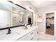 Luxurious bathroom with double sinks, quartz countertops, and a large mirror with modern lighting at 12609 Twilight Dr, Mint Hill, NC 28227
