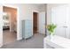 Transitional bedroom with an ensuite bathroom and decoratively painted dresser at 12609 Twilight Dr, Mint Hill, NC 28227