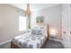 Serene bedroom with a decorative bedspread, bedside tables, and natural light from the window at 12609 Twilight Dr, Mint Hill, NC 28227