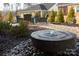 Backyard fountain surrounded by garden and mature landscaping at 12609 Twilight Dr, Mint Hill, NC 28227
