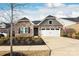Charming home with stone accents, a two-car garage, and manicured front yard at 12609 Twilight Dr, Mint Hill, NC 28227