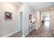 Inviting hallway with wood floors and neutral tones, leading to various rooms at 12609 Twilight Dr, Mint Hill, NC 28227