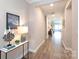 Inviting hallway with wood floors and neutral tones, providing a seamless flow at 12609 Twilight Dr, Mint Hill, NC 28227