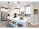 Modern kitchen featuring white cabinets, stainless steel appliances, and a spacious island at 12609 Twilight Dr, Mint Hill, NC 28227