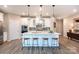 Modern kitchen with white cabinetry, stainless steel appliances, and a large center island at 12609 Twilight Dr, Mint Hill, NC 28227