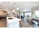 Bright, open-concept living room with a fireplace, hardwood floors, and natural light at 12609 Twilight Dr, Mint Hill, NC 28227