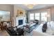Bright living room featuring a fireplace, large windows, and elegant furnishings at 12609 Twilight Dr, Mint Hill, NC 28227