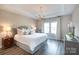 Serene main bedroom with tray ceiling, hardwood floors, and elegant chandelier at 12609 Twilight Dr, Mint Hill, NC 28227