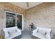 Covered patio featuring comfortable seating and brick surround at 12609 Twilight Dr, Mint Hill, NC 28227