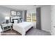 A cozy bedroom with a soft bed, neutral tones, and a tranquil view from the window at 128 Woodhall Way, Troutman, NC 28166