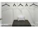 This is a closet with dark ottoman and white wire rack system for hanging clothes at 128 Woodhall Way, Troutman, NC 28166