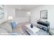 Upstairs living room offers a comfortable seating area, modern accents, and neutral decor at 128 Woodhall Way, Troutman, NC 28166