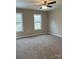 Bedroom with carpet floors, a ceiling fan, and two windows at 1425 Wildwood Dr, Kannapolis, NC 28081