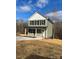 Inviting two-story home with green siding, black shutters, and covered front porch at 1425 Wildwood Dr, Kannapolis, NC 28081