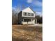 Two-story home featuring green siding, black shutters, and a welcoming covered front porch at 1425 Wildwood Dr, Kannapolis, NC 28081