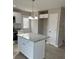 Well-lit kitchen with white cabinets, stainless appliances, an island, and wood-look flooring at 1425 Wildwood Dr, Kannapolis, NC 28081