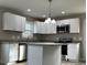 Modern kitchen with white cabinets, stainless steel appliances, and an island with granite countertop at 1425 Wildwood Dr, Kannapolis, NC 28081