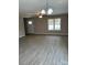 Open-plan living room with light gray walls, modern light fixture and view of the front yard at 1425 Wildwood Dr, Kannapolis, NC 28081