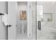 Bright bathroom features white marble tile, a glass enclosed shower, and modern black hardware at 17201 Green Hill Rd, Charlotte, NC 28278
