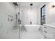 Spa-like bathroom with a soaking tub, glass shower, and modern fixtures and a marble motif at 17201 Green Hill Rd, Charlotte, NC 28278