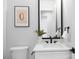 Stylish powder room featuring a modern vanity, designer mirror, and contemporary fixtures at 17201 Green Hill Rd, Charlotte, NC 28278