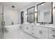 Luxurious primary bathroom featuring a soaking tub, dual vanities, and a glass-enclosed shower at 17201 Green Hill Rd, Charlotte, NC 28278
