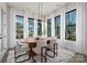 Elegant dining room with large windows, hardwood floors, and stylish chandelier lighting at 17201 Green Hill Rd, Charlotte, NC 28278