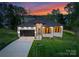 Beautiful single-story home featuring sleek architecture, well-kept lawn, and a modern garage at 17201 Green Hill Rd, Charlotte, NC 28278