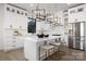 Modern kitchen with white cabinets, a quartz island with seating, and stainless steel appliances at 17201 Green Hill Rd, Charlotte, NC 28278