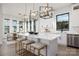 Bright, modern kitchen featuring a large island with bar seating, white cabinetry, and stylish pendant lighting at 17201 Green Hill Rd, Charlotte, NC 28278