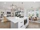 A modern kitchen with an island, stainless steel appliances, and an open view to the living room at 17201 Green Hill Rd, Charlotte, NC 28278