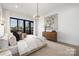 A well-lit main bedroom with a large bed, dresser, and balcony access at 17201 Green Hill Rd, Charlotte, NC 28278