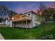 Back of the home featuring a spacious wooden deck, a well maintained lawn, and bright white brick at 17201 Green Hill Rd, Charlotte, NC 28278