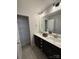 Modern bathroom featuring double sinks with black cabinets, a large mirror and tile floors at 228 Heatherland Dr, Rock Hill, SC 29732
